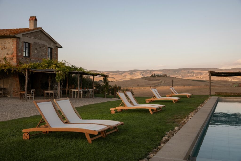 Relaxation by the pool at a scenic countryside retreat with loungers.